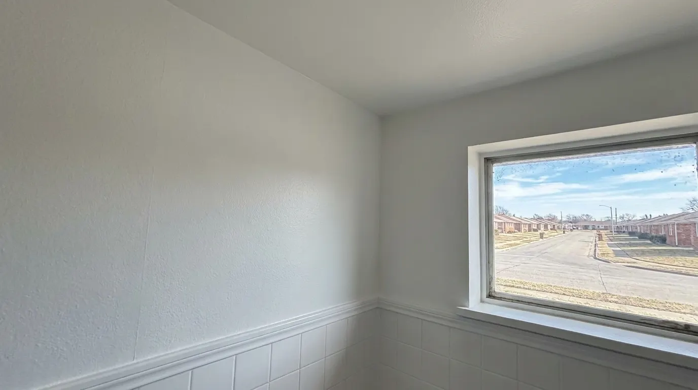 Same bathroom wall clean and repainted after mold remediation