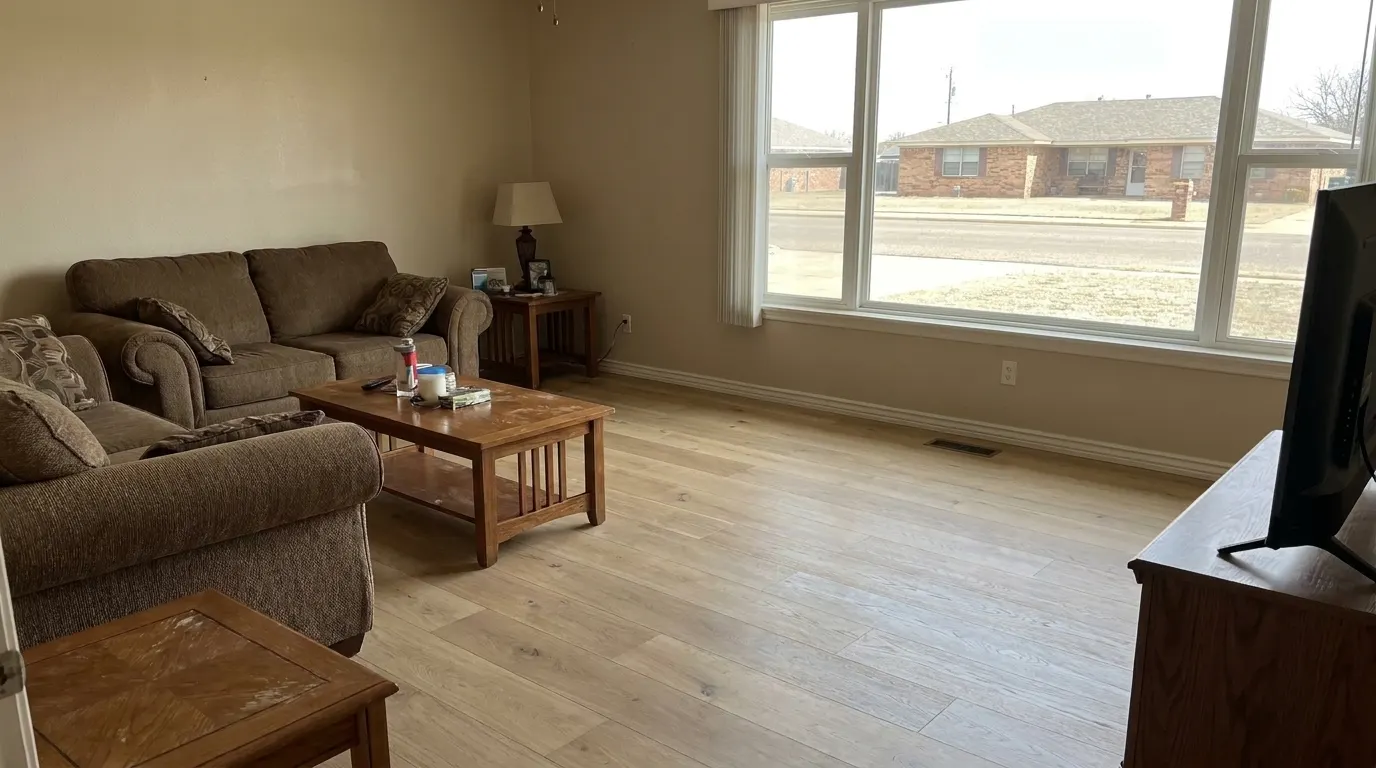 Same living room with new premium plank flooring and repaired walls after restoration